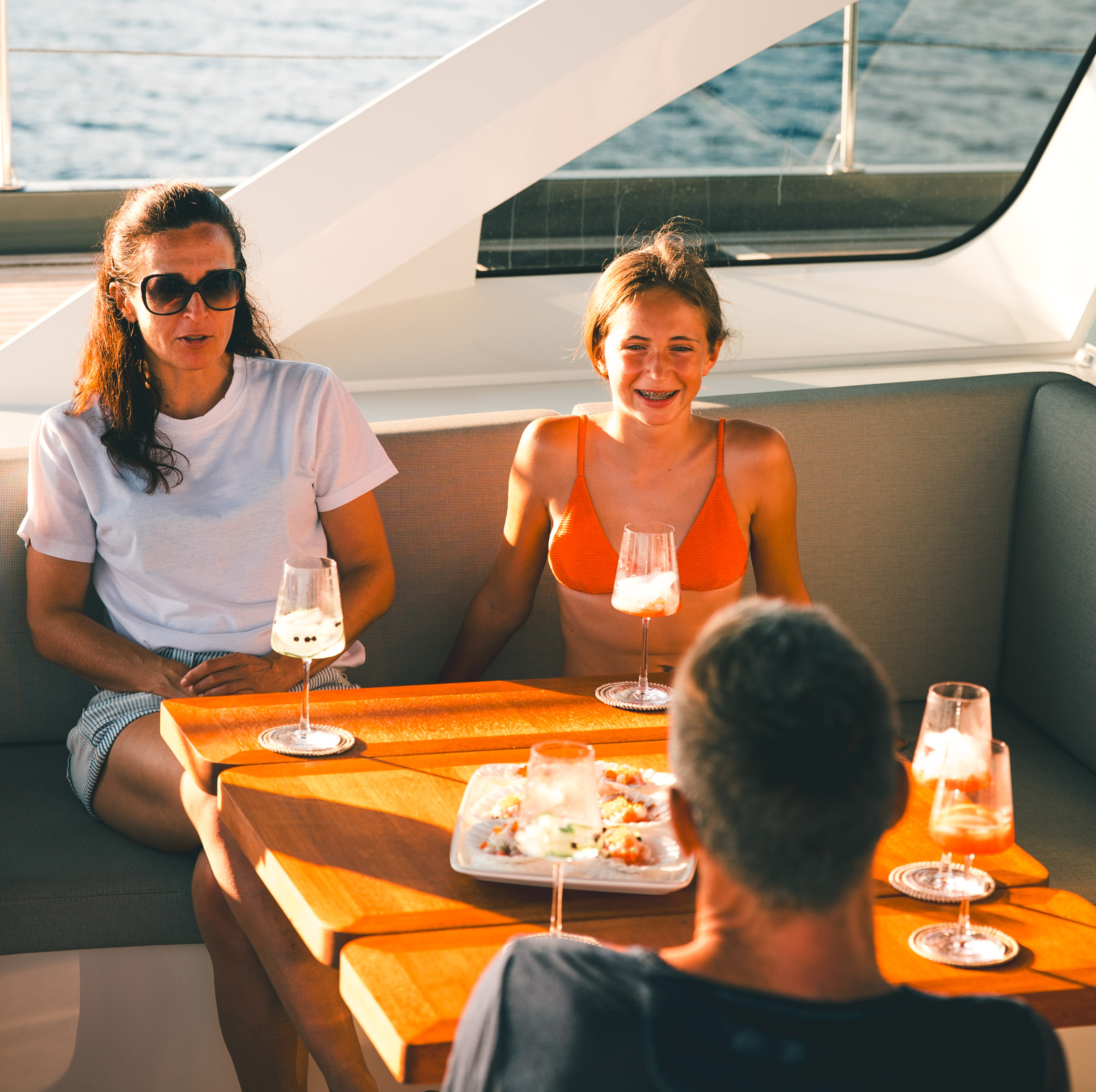 Comfortable salon with L-shaped sofa and modern galley